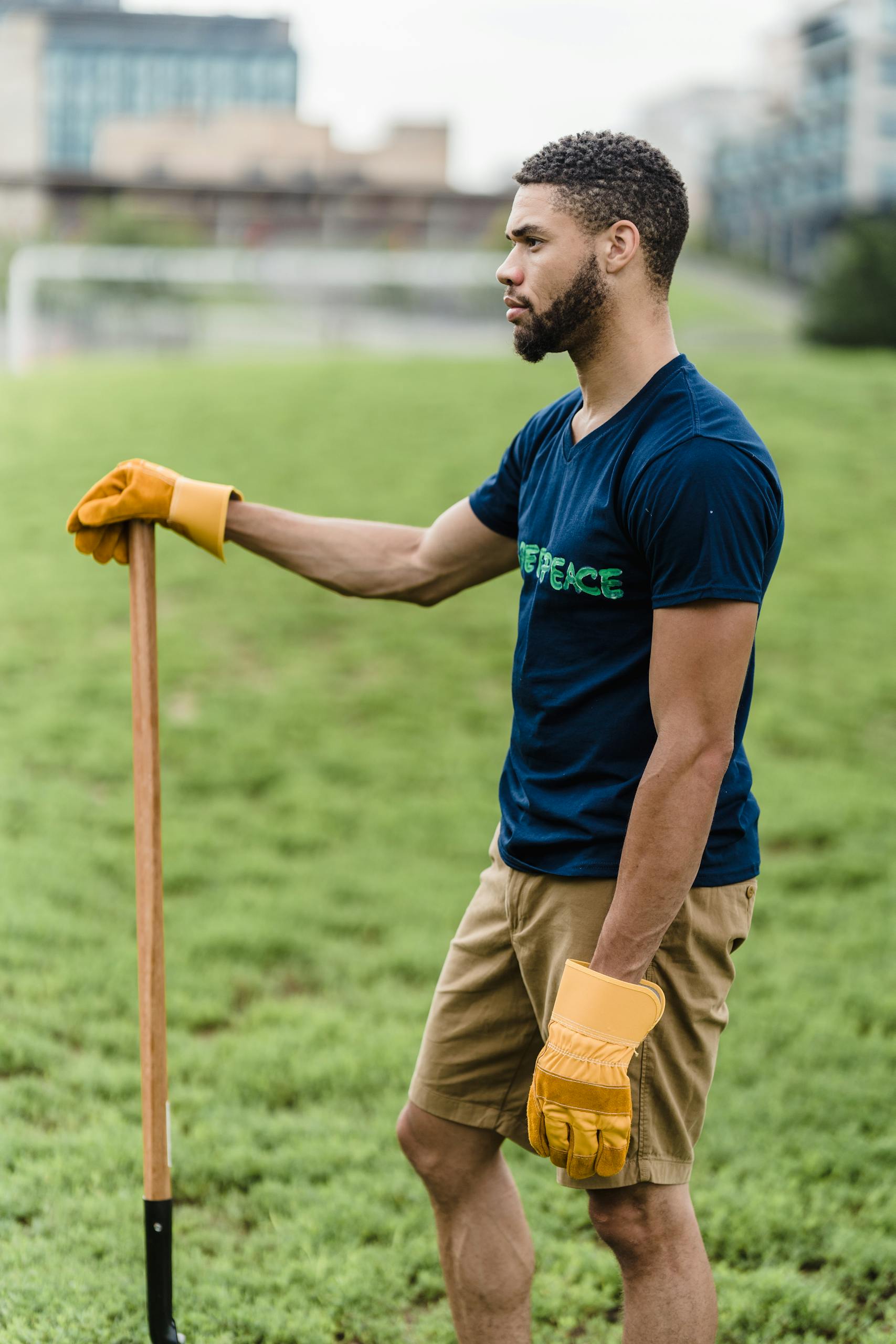 A young man volunteering in a public park, focusing on environmental conservation efforts.